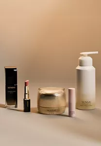 Must-haves for the holiday season next to each other on neutral surface with festive background